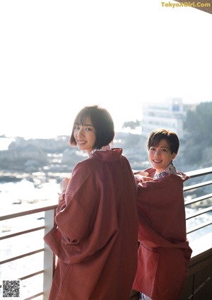 A couple of women laying in a pool of water.