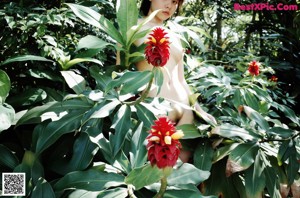 A naked woman holding a camera in her hands.
