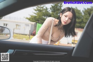 A woman tied up in the back seat of a car.