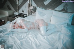 A woman dressed as a nurse standing in a room.