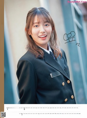 A woman in a black vest and white shirt posing for a calendar.