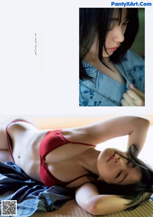 A woman in a black bra laying on a bed.