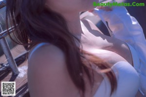 A woman in a white top and blue skirt posing for a picture.