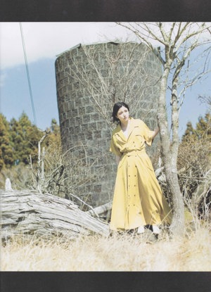 A woman with long black hair is posing for a magazine.