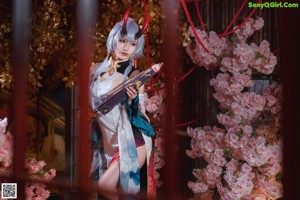 A woman in a red and white kimono holding an umbrella.