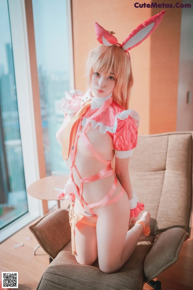 A woman in a bunny costume sitting on a chair.
