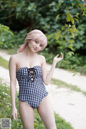 A woman dressed in a maid outfit posing for a picture.