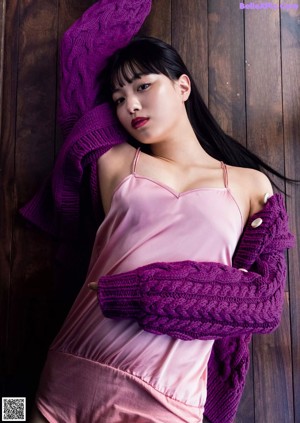 A woman in a white top and white shorts posing for a magazine.