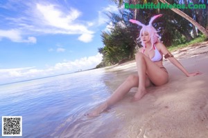 A woman in a bikini standing in the water.