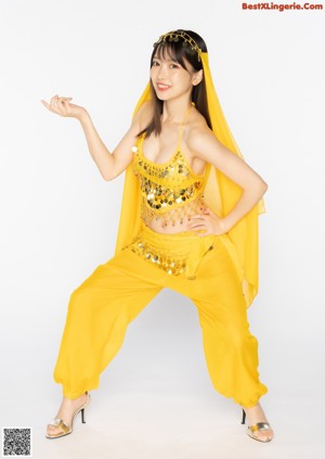 A woman in a red belly dance outfit posing for a picture.