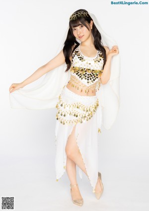 A woman in a red belly dance outfit posing for a picture.