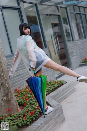 A woman in a white shirt and skirt holding an umbrella.