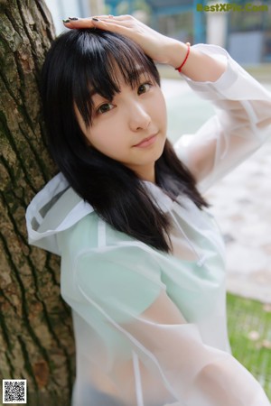 A woman in a white shirt leaning against a railing.